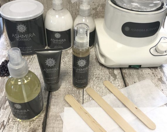 A display of natural Ashmira Botanica skincare products used at Beauty by Ruth to soothe skin and prevent irritation after professional waxing treatments.