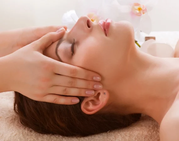 A professional skincare specialist performing a Liverpool Crystal Clear Microdermabrasion treatment to exfoliate and rejuvenate a client's complexion.