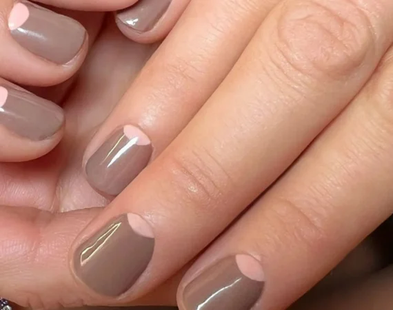 A professional nail technician at Beauty by Ruth applying a high-quality Gel Nail Polish base coat to ensure natural nail health and long-lasting colour.